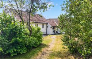 an old white house with trees and a driveway at Five-Bedroom Holiday Home In Mandal in Mandal