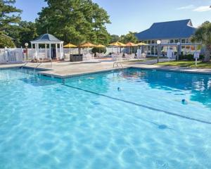 a large pool of blue water in a resort at Waterwood Townhouses in New Bern