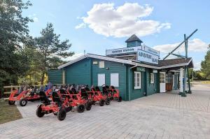 a group of atvs parked outside of a building at Caravan Holiday Home in Great Billing