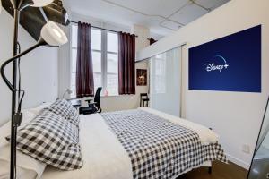 a bedroom with a bed and a large window at Entire 1 bedroom in the heart of KW downtown across Google in Kitchener