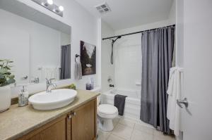 a white bathroom with a sink and a toilet at Entire 1 bedroom in the heart of KW downtown across Google in Kitchener +19 photos