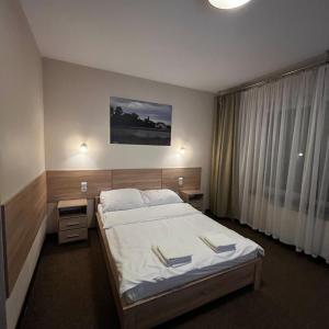 a hotel room with a bed and a window at Valda House in Rybie