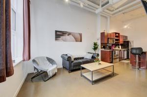 a living room with a couch and a table at Entire 1 bedroom in the heart of KW downtown across Google in Kitchener