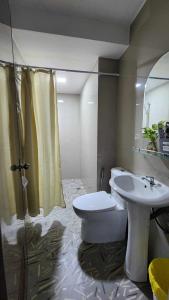 a bathroom with a toilet and a sink at LMS Guest House in Iloilo City