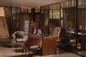 a lobby with a desk and chairs in a building at Radisson Blu Hotel Casablanca City Center in Casablanca +182 photos