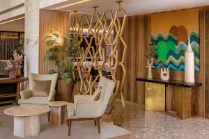 a lobby with two chairs and a table at Radisson Blu Hotel Casablanca City Center in Casablanca