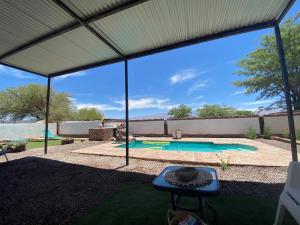a view of a swimming pool from under a tent at Cabañas Voyage Atacama in San Pedro de Atacama