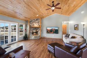 a living room with a ceiling fan and a fireplace at Mill 67 in South Fork
