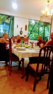 a group of people sitting at a table eating at Linwood Bungalow in Kandy