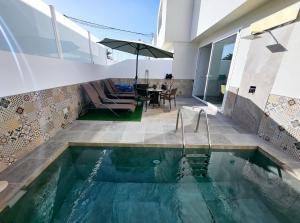 a swimming pool in the middle of a house at Villa Blue Moon in Tías
