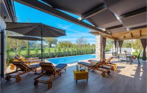 a patio with chairs and a swimming pool at Villa Acorn in Pula