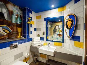 a bathroom with a sink and a mirror at LEGOLAND(R) Windsor Resort in Windsor