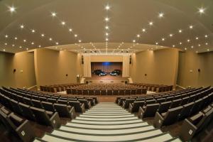 an empty auditorium with chairs and a stage at Kimpton Atlantico Algarve by IHG in Albufeira