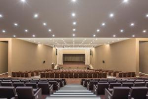 an empty lecture hall with chairs and a stage at Kimpton Atlantico Algarve by IHG in Albufeira