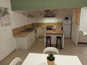 a small kitchen with a table and a counter top at Appartement théâtre antique in Orange