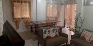 a living room with a table and two chairs at Balai Elmienna - solar powered farm house with pool in San Juan