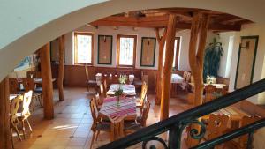 a dining room with a table and chairs at Cserhátvölgy Panzió in Alsótold