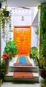 a front door of a house with plants at CLIFF HEAVEN Apartment in Varkala