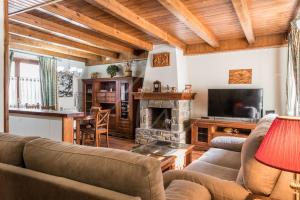 a living room with a couch and a fireplace at Casa Marimanha by SeaMount Rentals in Salardú