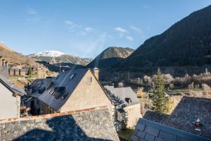 an aerial view of a house with mountains in the background at Casa Marimanha by SeaMount Rentals in Salardú
