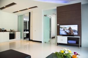 a living room with a flat screen tv at The L Resort Krabi - SHA Extra Plus in Ao Nang Beach