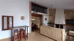 a kitchen and living room with a couch and a table at Cortijo Casablanca in Málaga