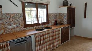a kitchen with a counter top and a window at Cortijo Casablanca in Málaga