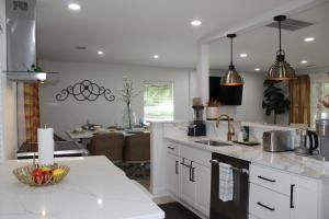 a kitchen with white cabinets and a counter top at Southern Elegance Gateway in McDonough