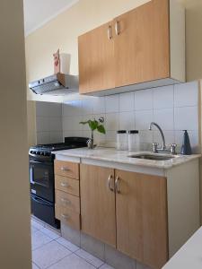 a kitchen with a sink and a stove at Azucena in Rafaela