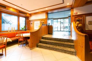a restaurant with stairs and a table and chairs at Hotel Grünwinkel in Oberharmersbach