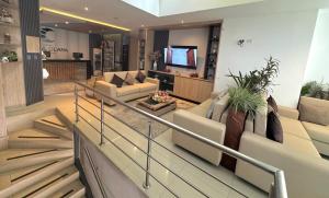a living room with two couches and a television at Hotel Santa Clara Boutique in Montería