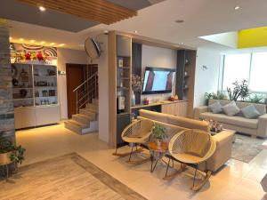 a living room with a couch and a table and chairs at Hotel Santa Clara Boutique in Montería +84 photos