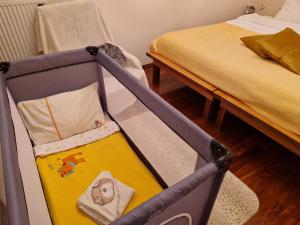 a baby crib in a room with a bed at Lake View in Ioannina
