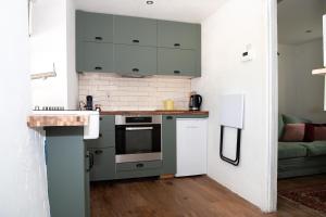 a kitchen with a sink and a stove top oven at Croan Cottage in Mayobridge