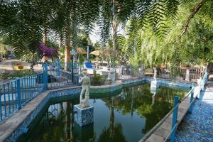 a pool of water with a statue in a park at Holiday Maison Villa Arci in Giardini Naxos