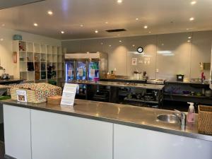 a large kitchen with a counter and a sink at YHA Nelson in Nelson