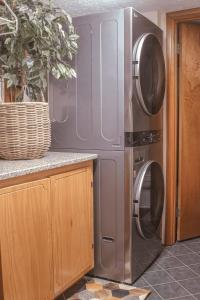 a kitchen with a refrigerator and a washing machine at Bustamante Ranch - Sovereign Lodge in McDonough