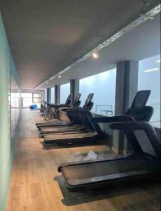 a row of treadmills in a gym with the ocean at Calido departamento Parque in Villa Marini +5 photos