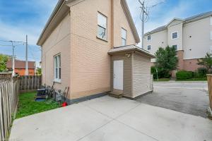 a small house with a door on the side of it at 4 Bedroom Luxury House, Free Parking, Next to LRT, Kitchener Downtown, near Chicopee Ski Club in Kitchener