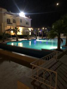 a large swimming pool at night with lights at Sharm El Sheikh nema downtown apartment in Sharm El Sheikh