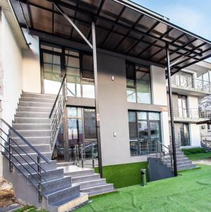 a building with a staircase in front of it at StarRent Apart-Hotel Self Check In in Chişinău