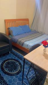 una camera da letto con un letto, un tavolo e un divano di Ruby Rooms a Slough