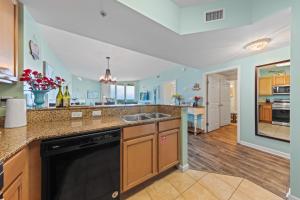 a large kitchen with a sink and a dishwasher at 5 Star Resort 11th Fl Stunning Sunrise 2BR 2BA King Suite,Pools ,Shuttle or Walk to Beach in Destin