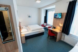 Ένα ή περισσότερα κρεβάτια σε δωμάτιο στο Prinsen Hotel