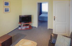 a living room with a tv and a bedroom at Ferienwohnung Peenemünde in Peenemünde