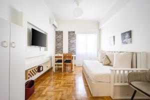 a living room with a bed and a table at Acropolis Delux 1st FLR Aprt up 4 guests by LODGESPOT in Athens