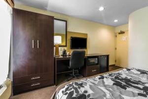 a bedroom with a bed and a desk with a computer at Sleep Inn in Lexington
