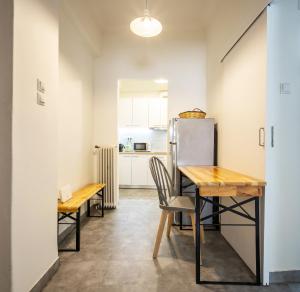 a kitchen with a table and chairs and a refrigerator at Acropolis Delux 1st FLR Aprt up 4 guests by LODGESPOT in Athens