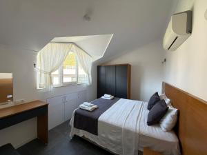 a bedroom with a bed and a sink and a window at AdaHan Family Rooms Gocek in Göcek +37 photos
