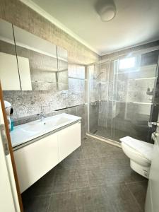 a bathroom with a toilet and a sink and a shower at AdaHan Family Rooms Gocek in Göcek